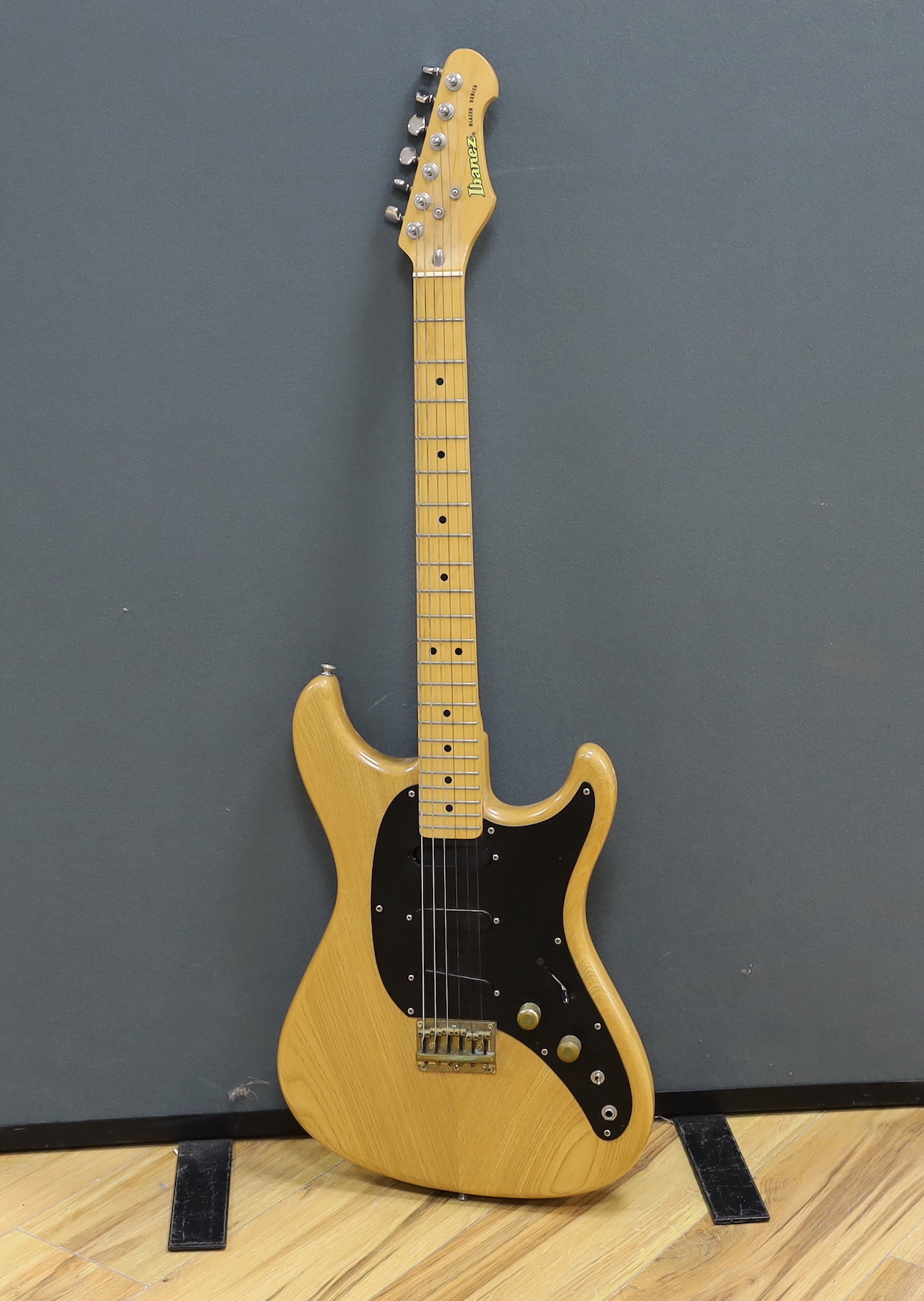 A 1980 Electric guitar by Ibanez, Japan, Blazer Series in natural finish with flight case and a small Fender Frontman 15G amp